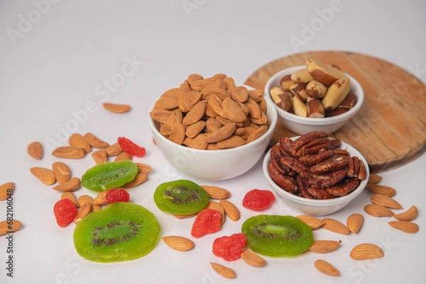 Fototapeta Mixed nuts on white bowl with white background, mixed dry fruits and nuts on white bowl with white background