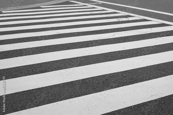 Fototapeta Zebra pattern line of the asphalt road, area for pedestrian crossing road safely. Transportation background photo.
