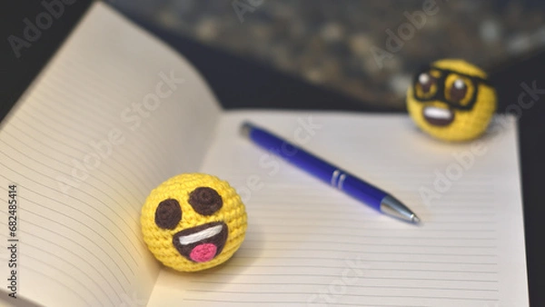 Fototapeta notebook, pen, nerd emoji and happy emoji amigurumis