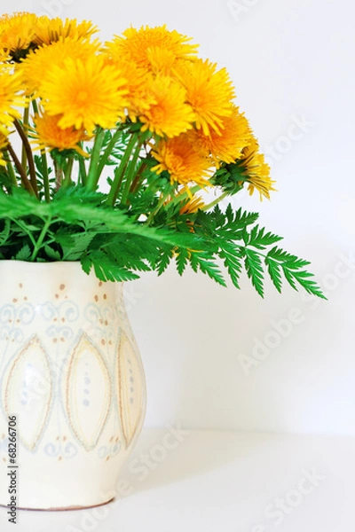 Fototapeta dandelions in a clay vase
