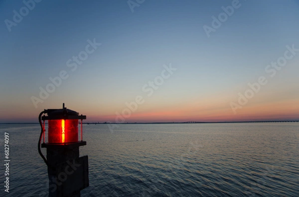 Obraz Red lantern by the sea at sunset