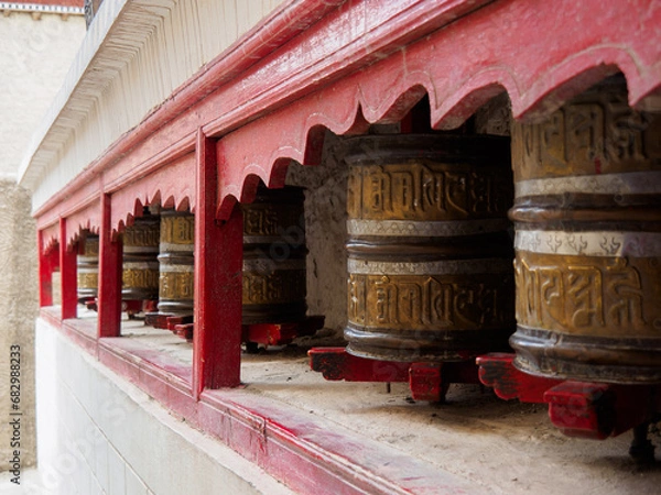 Obraz Metal Prayer Wheels at Shey Monastery or Gompa. A mantra 'Om Mani Padme Hum' was embossed on brass surface. Mantra is in Tibetan script and meaning is 'Praise to the Jewel in the Lotus’.