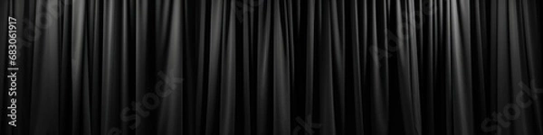Fototapeta Soft black curtain, folding vertically from top to bottom, close-up