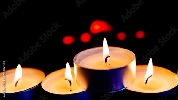 Obraz Three burning candles on black background