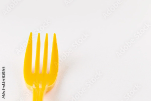 Fototapeta yellow fork on a white background