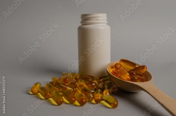 Fototapeta Omega-3 capsules lie in white bottle. Fish oil tablets. omega 6, 9, top view with copy space.