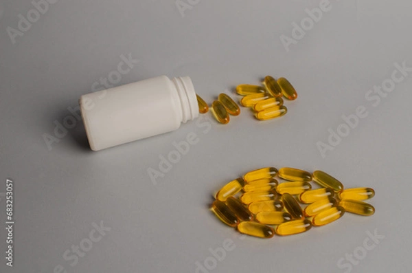 Fototapeta Omega 3 capsules - fish shape. Top view, copy space, high resolution product. Health care concept