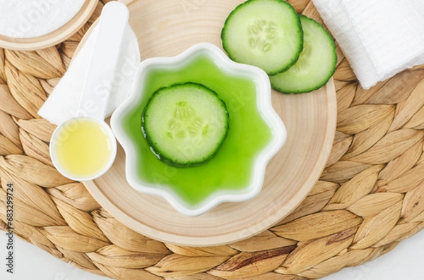 Obraz Cucumber juice and cucumber slice for preparing homemade facial mask, face toner or eye mask. Natural beauty treatment and spa recipe.