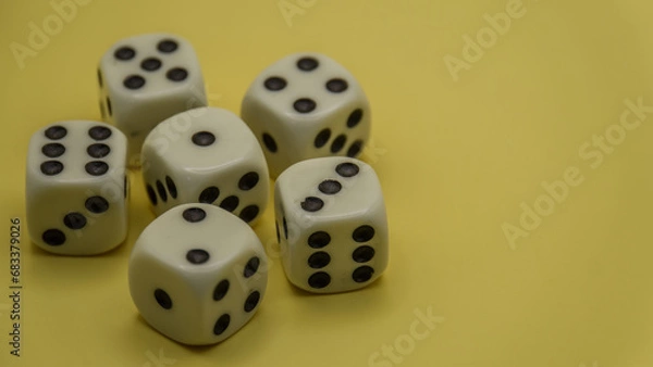 Fototapeta five dice cubes on a yellow background close up