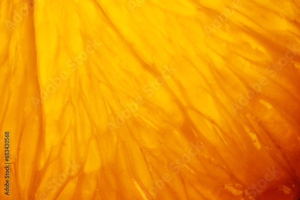 Fototapeta Orange slice with backlight, abstract macro photography orange fruit closeup background, citrus fruit texture