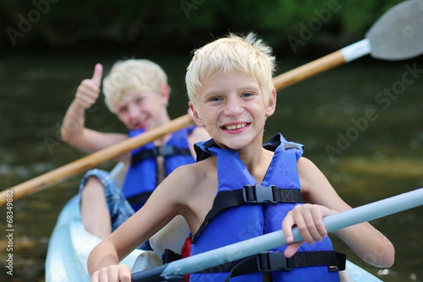 Fototapeta Two happy boys enjoying kayak on the river