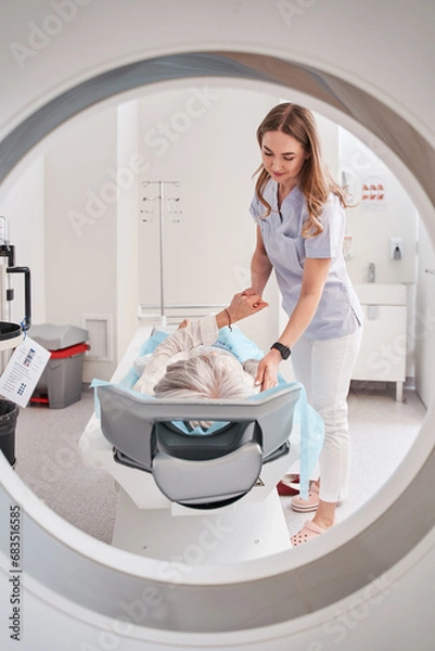 Fototapeta Doctor medical professional doing head or brain mri scan of patient