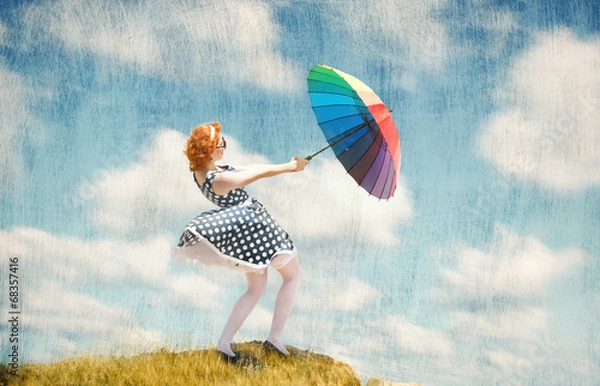 Fototapeta Retro style girl with colorful umbrella in the wind