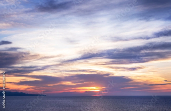 Fototapeta Sunset over sea in Corfu island in Greece. Summer time and mood. Beautiful vibrant evening. Copy space.