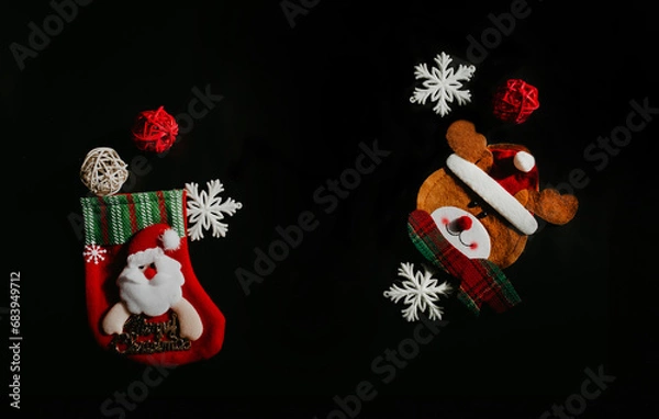 Fototapeta Christmas composition. Snowflakes, decorative balls, red sock, Christmas decorations on a black background. Christmas, winter, new year concept. Flat lay, top view, copy space