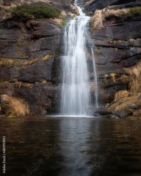 Obraz Beautiful Kopren waterfall on Stara planina, long exposure, blurred motion water cascading down the red cliff