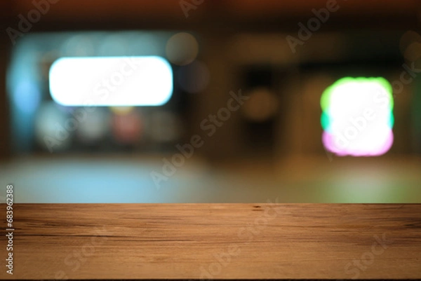Fototapeta Beautiful empty wood table top counter, window view. Wooden table with blur bokeh background ready for product montage. Abstract blurred bokeh neutral background of city, shop, store, restaurant, city