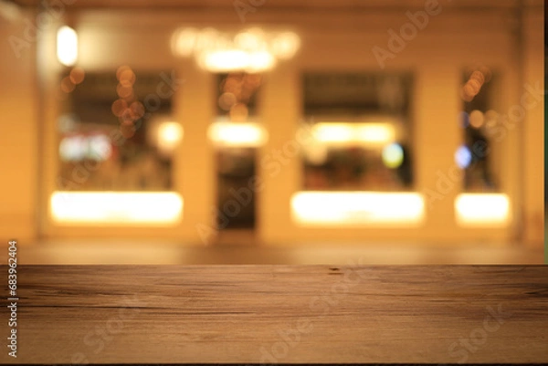 Fototapeta Beautiful empty wood table top counter, window view. Wooden table with blur bokeh background ready for product montage. Abstract blurred bokeh neutral background of city, shop, store, restaurant, city