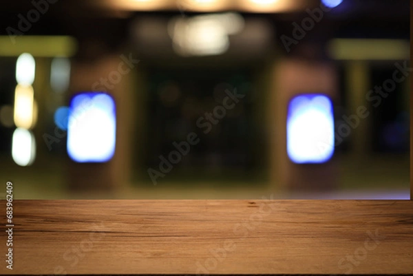 Fototapeta Beautiful empty wood table top counter, window view. Wooden table with blur bokeh background ready for product montage. Abstract blurred bokeh neutral background of city, shop, store, restaurant, city