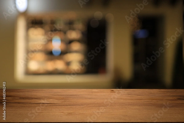 Fototapeta Beautiful empty wood table top counter, window view. Wooden table with blur bokeh background ready for product montage. Abstract blurred bokeh neutral background of city, shop, store, restaurant, city