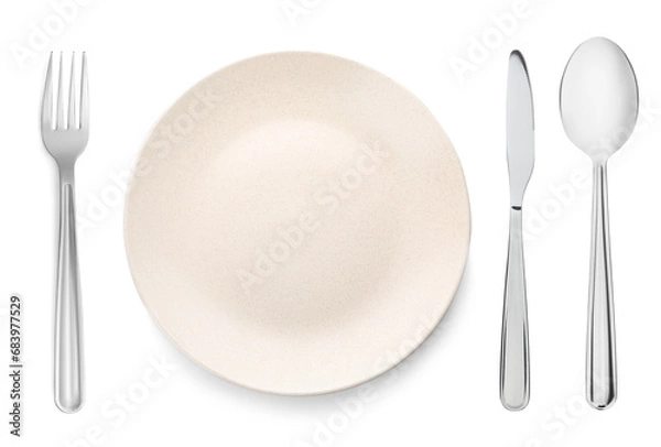 Fototapeta Empty beige plate with fork, knife and spoon on white background, top view