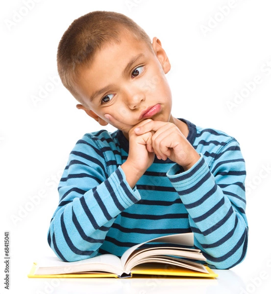 Obraz Little boy is tired to read his book
