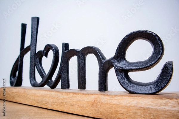 Obraz home, decorative figure with the word home made of black metal and wood on a white background