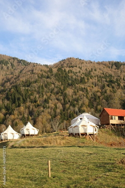 Obraz View of glamping tent on the nature in the beautiful countryside in the mountains in summer. White tent glamping camp. Luxury campsite.
