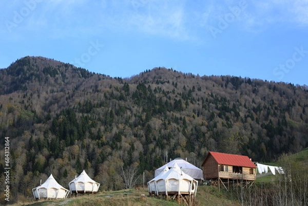 Obraz View of glamping tent on the nature in the beautiful countryside in the mountains in summer. White tent glamping camp. Luxury campsite.
