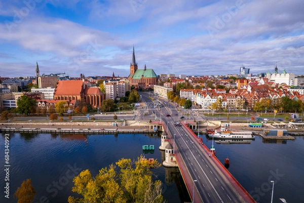 Fototapeta Szczecin from a bird's eye view on a sunny day. View of the city from the Oder River. City buildings, the seaport in Szczecin and its most characteristic places.