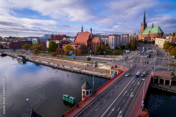 Fototapeta Szczecin from a bird's eye view on a sunny day. View of the city from the Oder River. City buildings, the seaport in Szczecin and its most characteristic places.