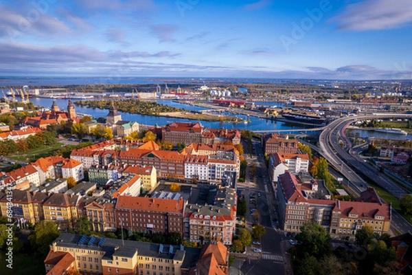 Fototapeta Szczecin from a bird's eye view on a sunny day. View of the city from the Oder River. City buildings, the seaport in Szczecin and its most characteristic places.