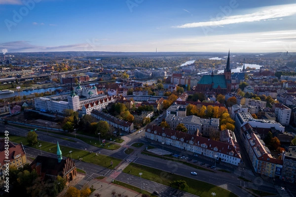 Fototapeta Szczecin from a bird's eye view on a sunny day. View of the city from the Oder River. City buildings, the seaport in Szczecin and its most characteristic places.