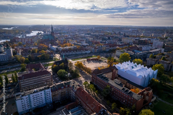 Fototapeta Szczecin from a bird's eye view on a sunny day. View of the city from the Oder River. City buildings, the seaport in Szczecin and its most characteristic places.