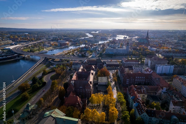 Fototapeta Szczecin from a bird's eye view on a sunny day. View of the city from the Oder River. City buildings, the seaport in Szczecin and its most characteristic places.