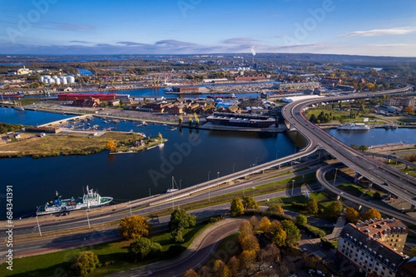 Fototapeta Szczecin from a bird's eye view on a sunny day. View of the city from the Oder River. City buildings, the seaport in Szczecin and its most characteristic places.