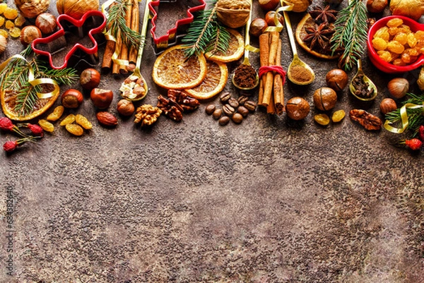 Fototapeta The concept of a background for baking with spices, nuts and dishes for Christmas cookies. Christmas or New Year background for presentation and advertising.