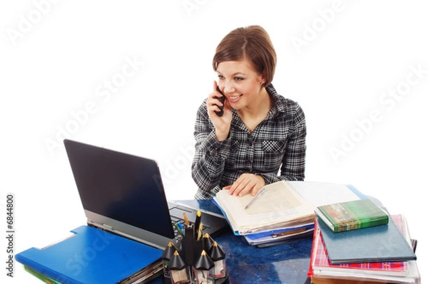 Fototapeta Business woman in the office talking on the phone.