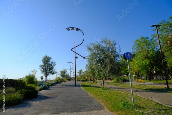 Fototapeta Adriatic promenade in Rimini, Emilia-Romagna with street lamps in the shape of the letter R on a sunny day