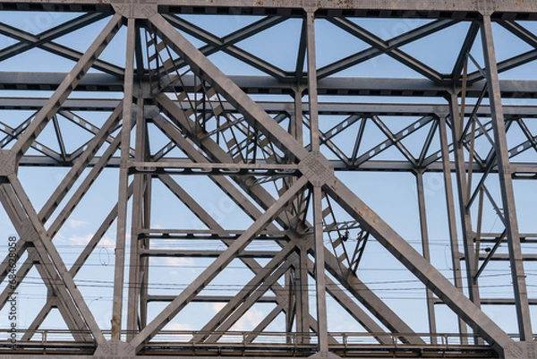 Obraz Yaroslavl, Russia, July 8, 2023. Structures of a railway bridge against the sky.