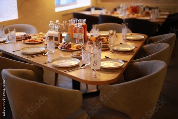 Fototapeta decorated banquet table with service in a restaurant at an event