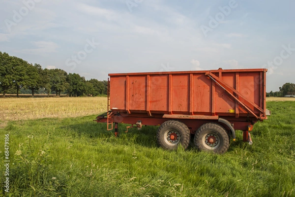 Fototapeta Red trailer on field