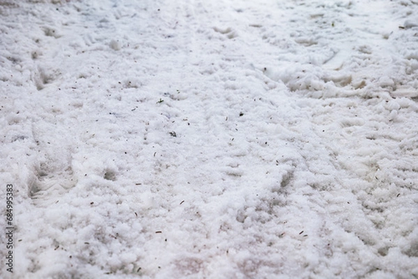 Fototapeta path covered in snow. close-up of a snow path. ground view in winter. path of disturbed snow. close up of snow on the ground