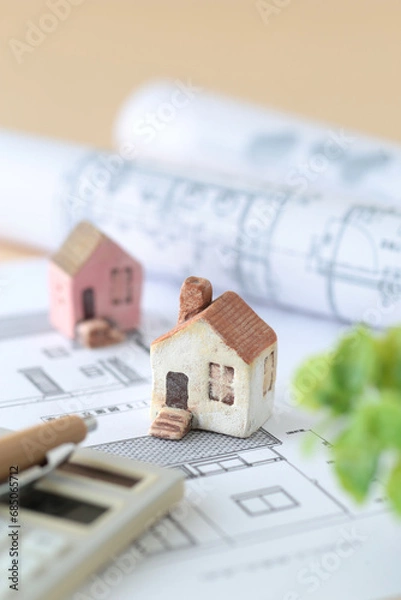 Fototapeta ミニチュアの家と設計図を使ったマイホームの購入を考えるイメージ