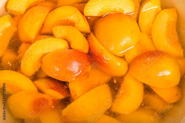 Obraz Bowl of fresh sliced peaches in syrup