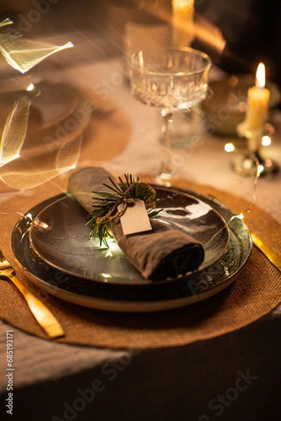 Fototapeta winter holidays, dinner party and celebration concept - close up of scandinavian christmas table serving with burning candles at home at night