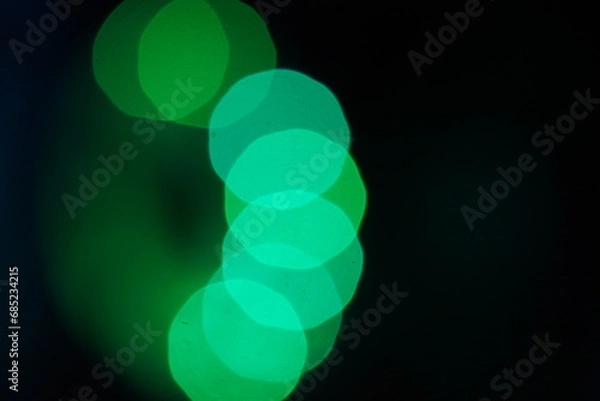 Fototapeta Green bokeh background  on black 