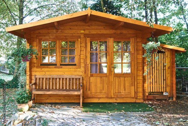 Obraz Beautiful wood cabin with gazebo, surrounded by trees and plants.