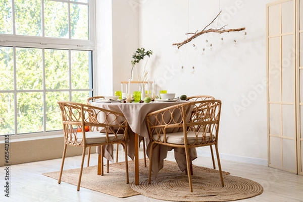 Fototapeta Autumn table setting decorated for Thanksgiving Day with pumpkins and chestnuts in light dining room