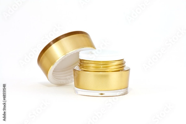 Obraz Gold cream container on white background